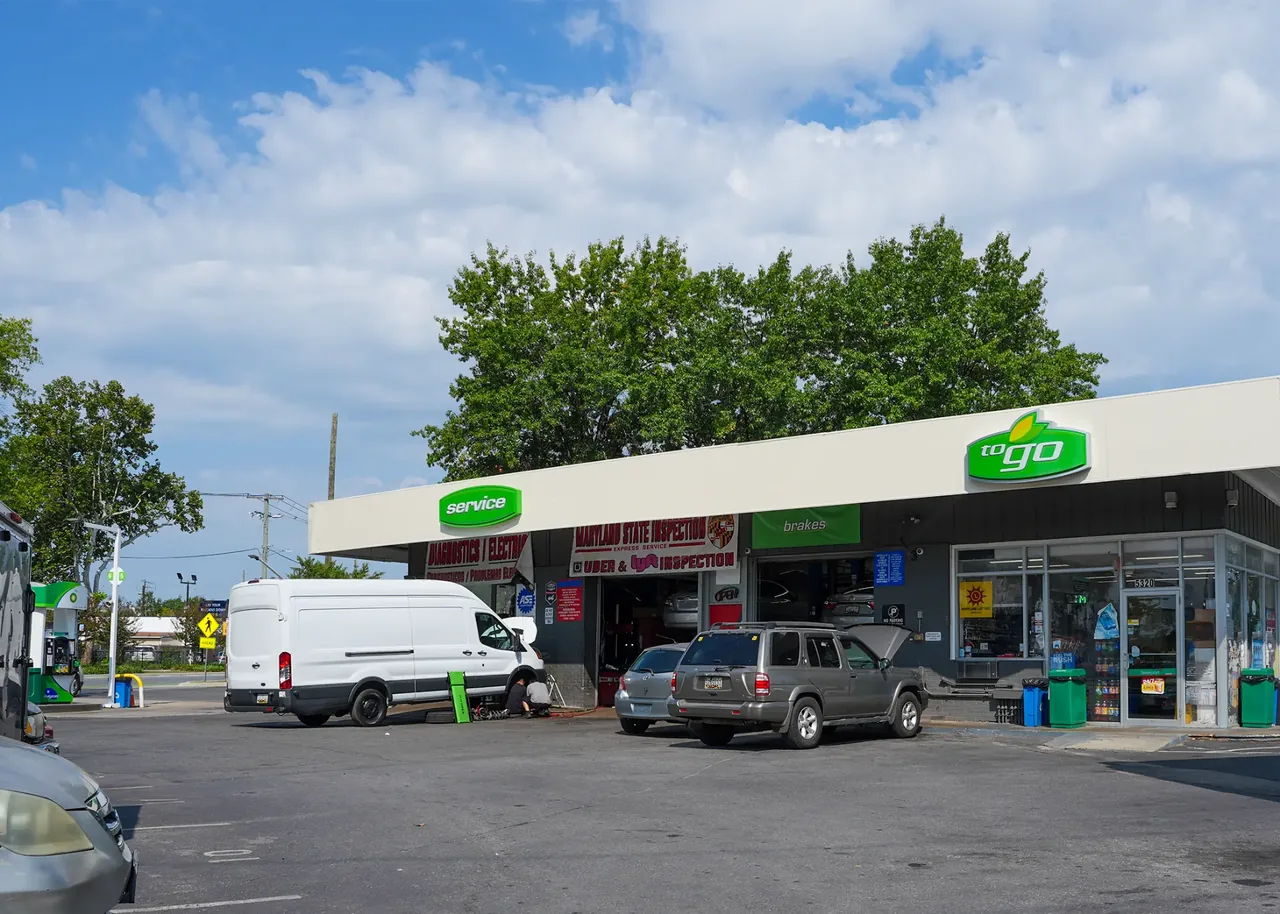 Queens Auto Repair storefront with Maryland State Inspection and Uber and Lyft inspection signs